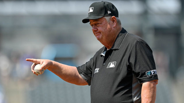 DENVER, COLORADO - SEPTEMBER 8: Umpire Joe West #22 looks on as he stands at first base during a game between the Colorado Rockies and the San Francisco Giants at Coors Field on September 8, 2021 in Denver, Colorado.