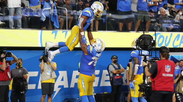 INGLEWOOD, CALIFORNIA - OCTOBER 04: Austin Ekeler #30 of the Los Angeles Chargers celebrates his touchdown with teammate offensive guard Oday Aboushi #76 against the Las Vegas Raiders during the second quarter at SoFi Stadium on October 4, 2021 in Inglewood, California.