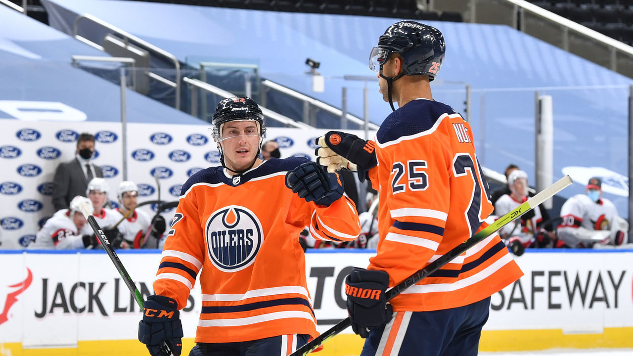 EDMONTON, AB - JANUARY 31: Tyson Barrie #22 and Darnell Nurse #25 of the Edmonton Oilers celebrate after a goal during the game against the Ottawa Senators on January 31, 2021 at Rogers Place in Edmonton, Alberta, Canada.