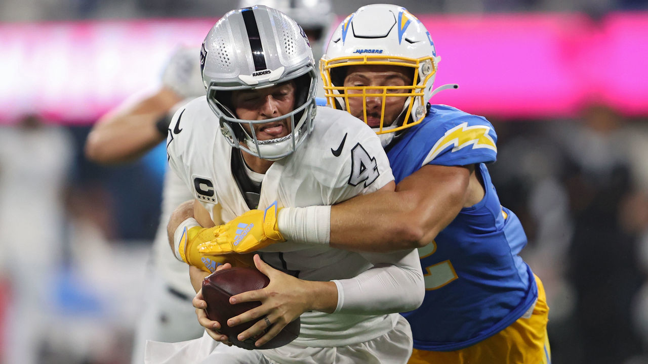 INGLEWOOD, CALIFORNIA - OCTOBER 04: Quarterback Derek Carr #4 of the Las Vegas Raiders is tackled by linebacker Kyler Fackrell #52 of the Los Angeles Chargers during the second half at SoFi Stadium on October 4, 2021 in Inglewood, California.