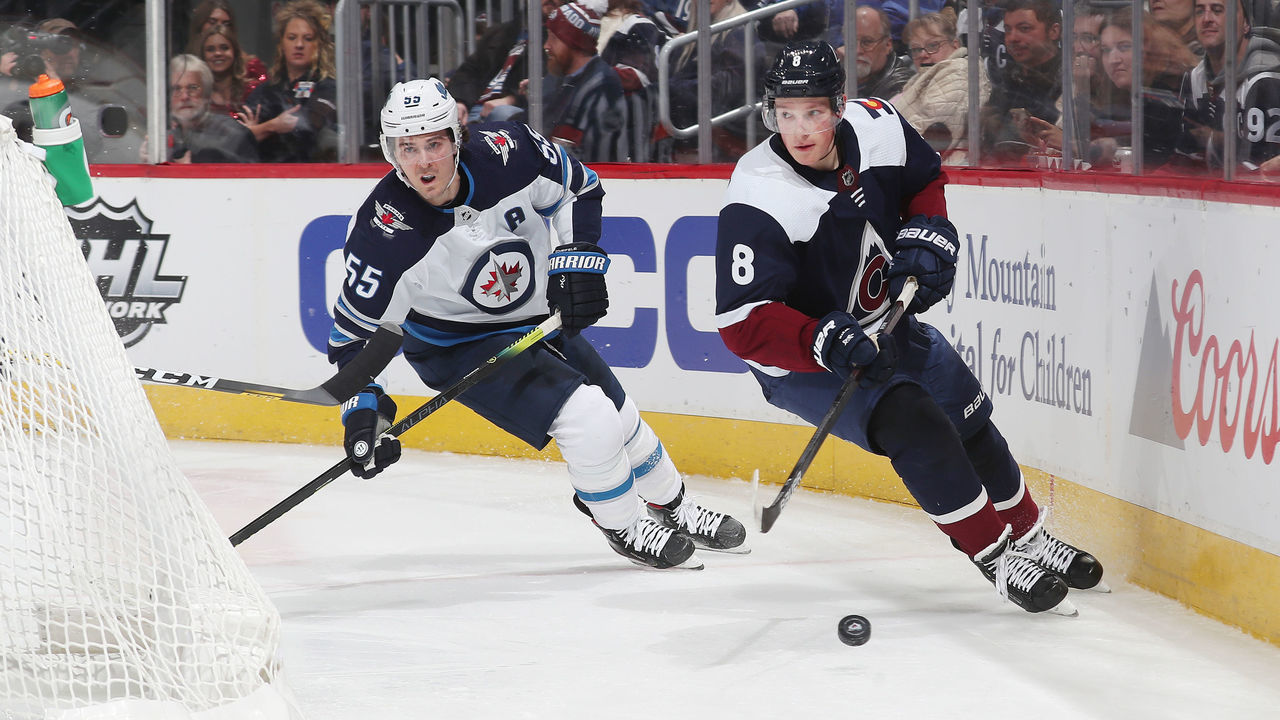 DENVER, COLORADO - DECEMBER 31: Cale Makar #8 of the Colorado Avalanche skates against Mark Scheifele #55 of the Winnipeg Jets at Pepsi Center on December 31, 2019 in Denver, Colorado.