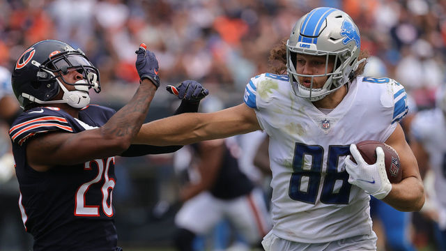 CHICAGO, ILLINOIS - OCTOBER 03: T.J. Hockenson #88 of the Detroit Lions straight-arms Deon Bush #26 of the Chicago Bears while running with the ball in the second half at Soldier Field on October 03, 2021 in Chicago, Illinois.