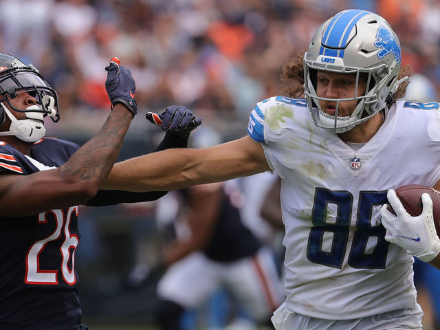 CHICAGO, ILLINOIS - OCTOBER 03: T.J. Hockenson #88 of the Detroit Lions straight-arms Deon Bush #26 of the Chicago Bears while running with the ball in the second half at Soldier Field on October 03, 2021 in Chicago, Illinois.
