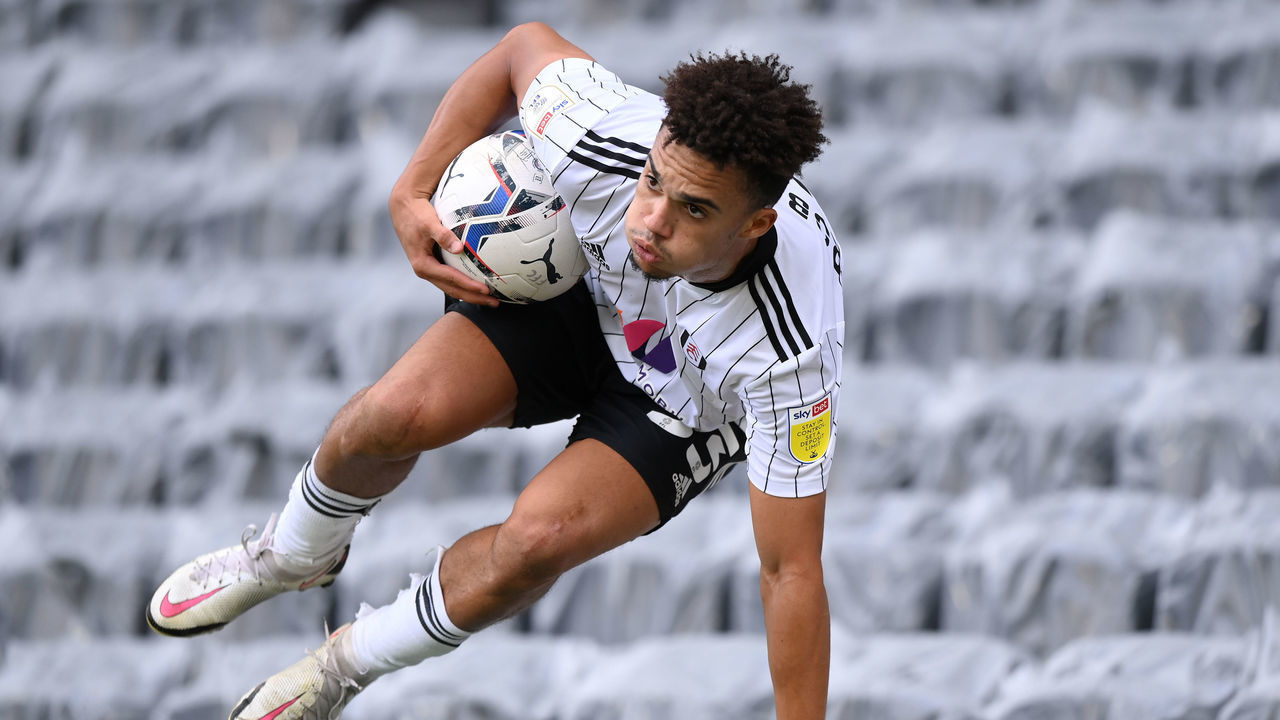 LONDON, ENGLAND - SEPTEMBER 18: Antonee Robinson of Fulham hurdles the advertising boards after collecting the ball from the stands during the Sky Bet Championship match between Fulham and Reading at Craven Cottage on September 18, 2021 in London, England.