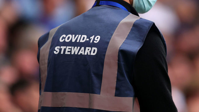 LONDON, ENGLAND - SEPTEMBER 25: COVID-19 stewards during the Premier League match between Chelsea and Manchester City at Stamford Bridge on September 25, 2021 in London, England.