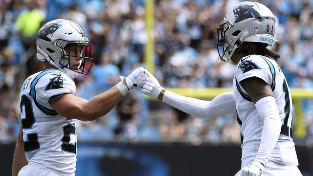 CHARLOTTE, NORTH CAROLINA - SEPTEMBER 19: Wide receiver Robby Anderson #11 fist bumps running back Christian McCaffrey #22 of the Carolina Panthers during their football game against the New Orleans Saints at Bank of America Stadium on September 19, 2021 in Charlotte, North Carolina.