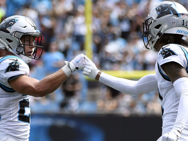 CHARLOTTE, NORTH CAROLINA - SEPTEMBER 19: Wide receiver Robby Anderson #11 fist bumps running back Christian McCaffrey #22 of the Carolina Panthers during their football game against the New Orleans Saints at Bank of America Stadium on September 19, 2021 in Charlotte, North Carolina.