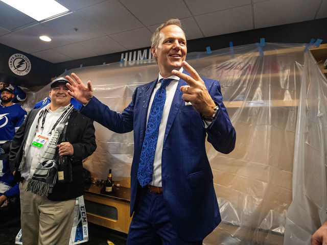 TAMPA, FL - JULY 7: Head Coach Jon Cooper of the Tampa Bay Lightning celebrates in the locker room with the Stanley Cup after the Tampa Bay Lightning defeated the Montreal Canadiens in Game Five to win the best of seven game series 4-1 during the Stanley Cup Final of the 2021 Stanley Cup Playoffs at Amalie Arena on July 7, 2021 in Tampa, Florida.