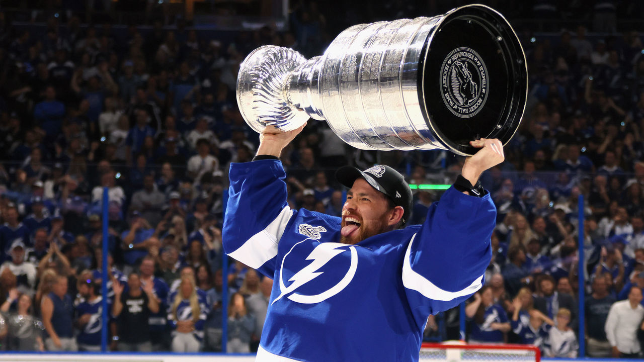 TAMPA, FLORIDA - JULY 07: Curtis McElhinney #35 of the Tampa Bay Lightning celebrates with the Stanley Cup following the victory over the Montreal Canadiens in Game Five of the 2021 NHL Stanley Cup Final at the Amalie Arena on July 07, 2021 in Tampa, Florida. The Lightning defeated the Canadiens 1-0 to take the series four games to one.
