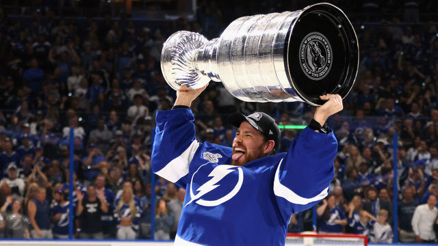 TAMPA, FLORIDA - JULY 07: Curtis McElhinney #35 of the Tampa Bay Lightning celebrates with the Stanley Cup following the victory over the Montreal Canadiens in Game Five of the 2021 NHL Stanley Cup Final at the Amalie Arena on July 07, 2021 in Tampa, Florida. The Lightning defeated the Canadiens 1-0 to take the series four games to one.