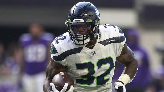 MINNEAPOLIS, MINNESOTA - SEPTEMBER 26: Chris Carson #32 of the Seattle Seahawks runs the ball for a touchdown during the second quarter in the game against the Minnesota Vikings at U.S. Bank Stadium on September 26, 2021 in Minneapolis, Minnesota.