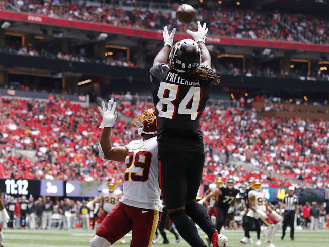 ATLANTA, GEORGIA - OCTOBER 03: Cordarrelle Patterson #84 of the Atlanta Falcons scores a touchdown reception against Kendall Fuller #29 of the Washington Football Team in the third quarter at Mercedes-Benz Stadium on October 03, 2021 in Atlanta, Georgia.