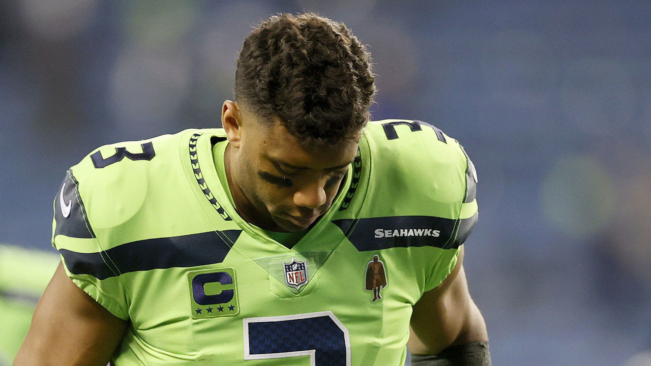 SEATTLE, WASHINGTON - OCTOBER 07:Russell Wilson #3 of the Seattle Seahawks jogs off the field while tending to his finger injury after losing 26-17 to the Los Angeles Rams at Lumen Field on October 07, 2021 in Seattle, Washington.