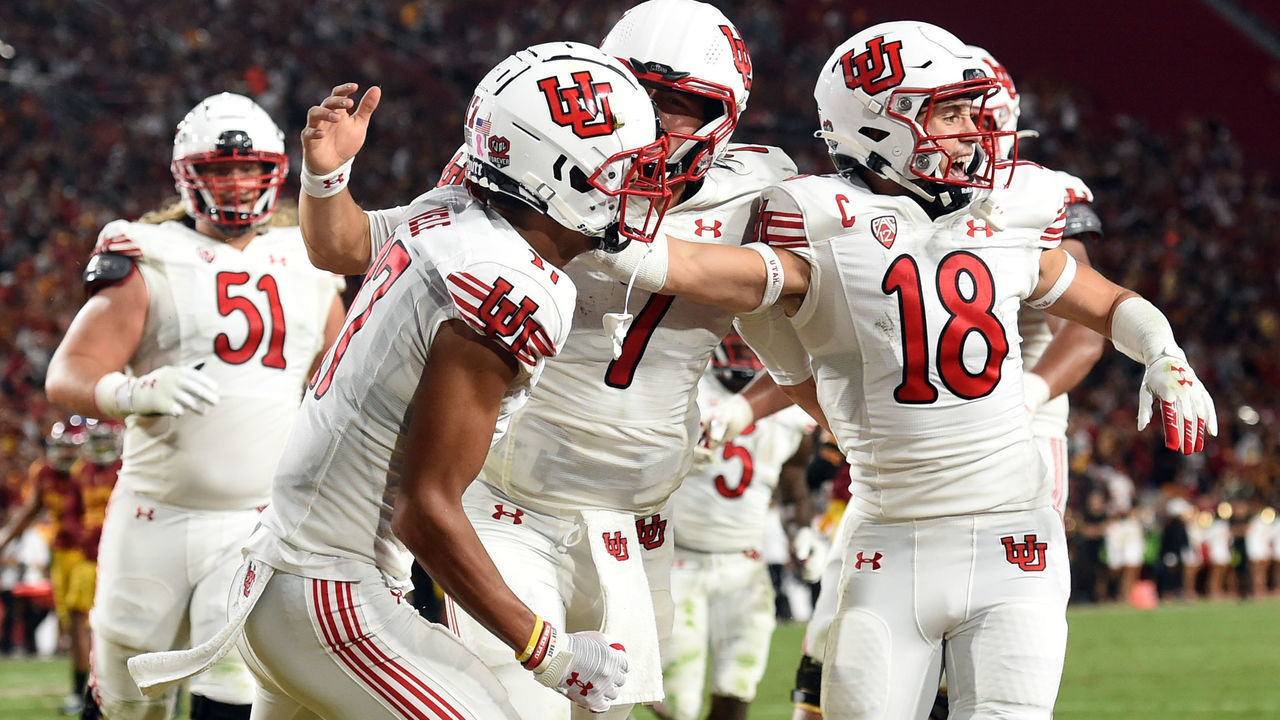 LOS ANGELES, CA - OCTOBER 09: Utah Utes wide receiver Devaughn Vele (17) celebrates after catching a pass for a touchdown with Utah Utes quarterback Cameron Rising (7) and Utah Utes wide receiver Britain Covey (18) at the end of the first half during a college football game between the Utah Utes and the USC Trojans on October 9, 2021, at the Los Angeles Memorial Coliseum in Los Angeles, CA.