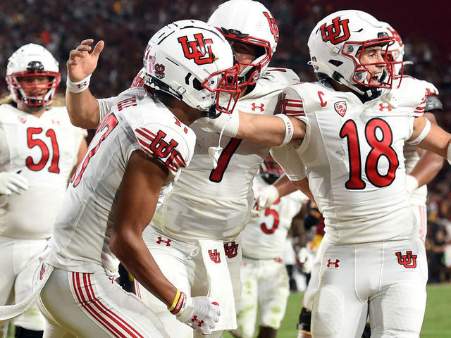 LOS ANGELES, CA - OCTOBER 09: Utah Utes wide receiver Devaughn Vele (17) celebrates after catching a pass for a touchdown with Utah Utes quarterback Cameron Rising (7) and Utah Utes wide receiver Britain Covey (18) at the end of the first half during a college football game between the Utah Utes and the USC Trojans on October 9, 2021, at the Los Angeles Memorial Coliseum in Los Angeles, CA.