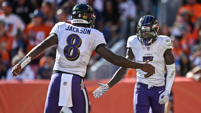 DENVER, CO - OCTOBER 3: Lamar Jackson #8 and Marquise Brown #5 of the Baltimore Ravens celebrate after connecting for a second quarter touchdown against the Denver Broncos at Empower Field at Mile High on October 3, 2021 in Denver, Colorado.