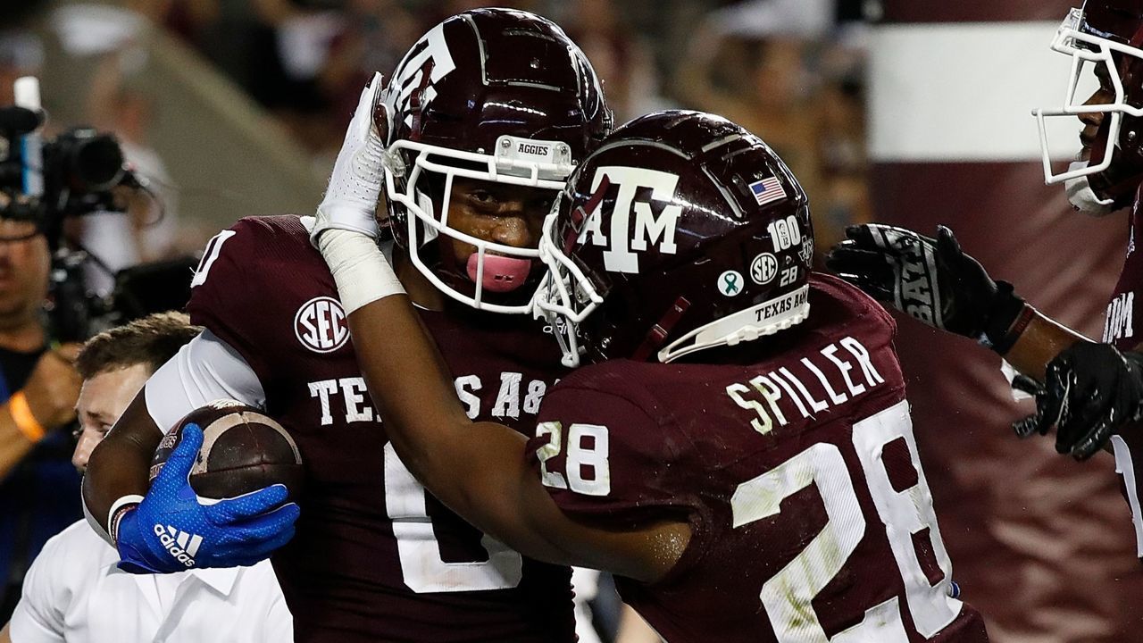 COLLEGE STATION, TEXAS - OCTOBER 09: Ainias Smith #0 of the Texas A&M Aggies celebrates with Isaiah Spiller #28 after catching a 6 yard pass for a touchdown in the first half against the Alabama Crimson Tide at Kyle Field on October 09, 2021 in College Station, Texas.