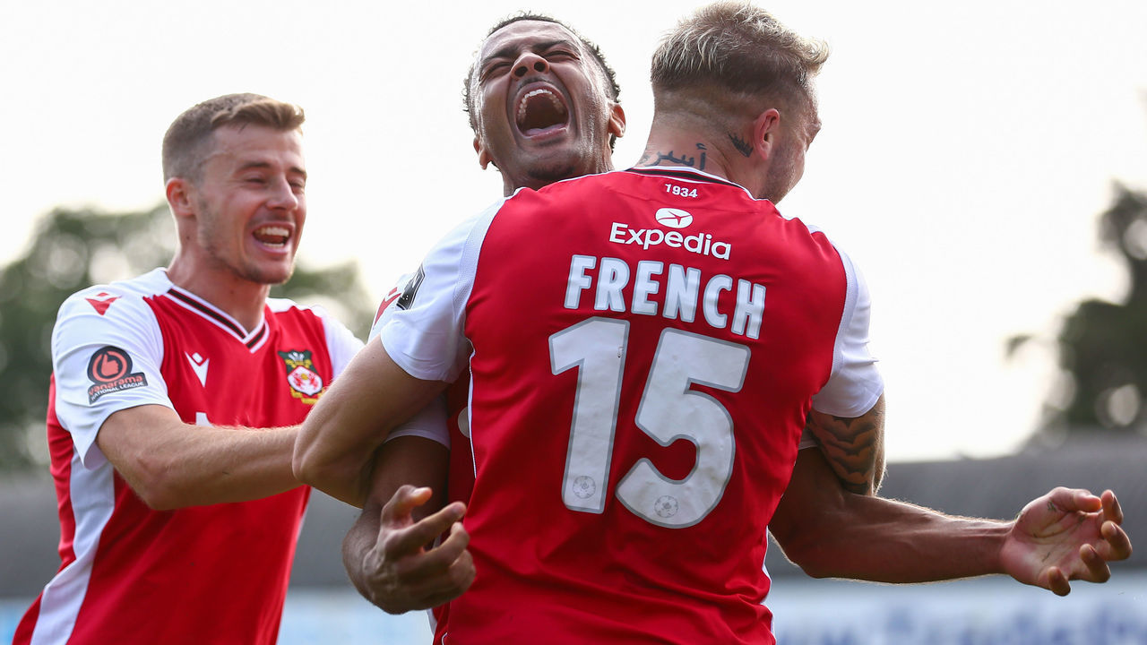 SOUTHEND, ENGLAND - SEPTEMBER 04: Dior Angus of Wrexham celebrates after scoring their team's second goal with Tyler French of Wrexham during the Vanarama National League match between Southend United and Wrexham at Roots Hall on September 04, 2021 in Southend, England.