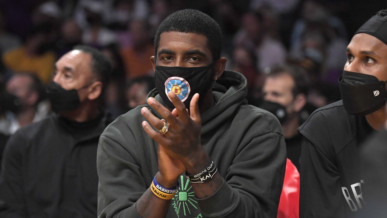 LOS ANGELES, CA - OCTOBER 03: Kyrie Irving #11 of the Brooklyn Nets cheers from the bench during a pre season game against the Los Angeles Lakers at Staples Center on October 3, 2021 in Los Angeles, California. NOTE TO USER: User expressly acknowledges and agrees that, by downloading and/or using this Photograph, user is consenting to the terms and conditions of the Getty Images License Agreement.