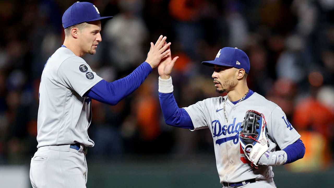 SAN FRANCISCO, CALIFORNIA - OCTOBER 09: Corey Seager #5 and Mookie Betts #50 of the Los Angeles Dodgers celebrate after beating the San Francisco Giants 9-2 in Game 2 of the National League Division Series at Oracle Park on October 09, 2021 in San Francisco, California.