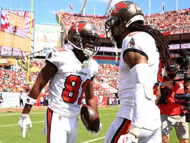 TAMPA, FLORIDA - OCTOBER 10: Antonio Brown #81 of the Tampa Bay Buccaneers celebrates a touchdown with Richard Sherman #5 during the second quarter against the Miami Dolphins at Raymond James Stadium on October 10, 2021 in Tampa, Florida.