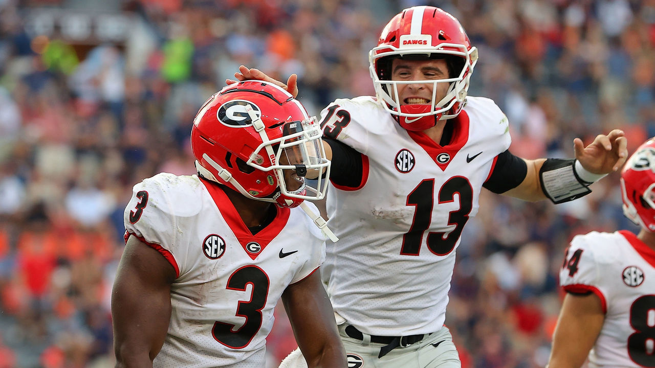 AUBURN, ALABAMA - OCTOBER 09: Zamir White #3 of the Georgia Bulldogs reacts after rushing for a touchdown against the Auburn Tigers with Stetson Bennett #13 during the second half at Jordan-Hare Stadium on October 09, 2021 in Auburn, Alabama.