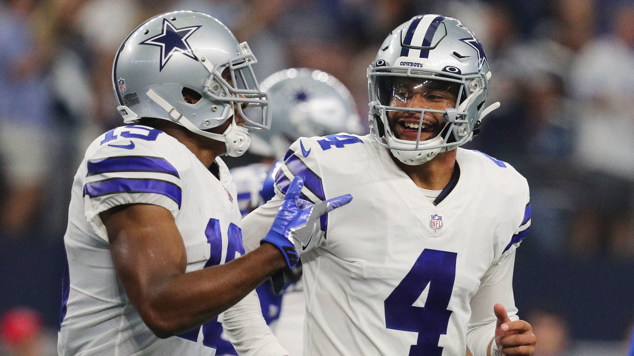 ARLINGTON, TEXAS - OCTOBER 10: Dak Prescott #4 of the Dallas Cowboys celebrates with Amari Cooper #19 after a touchdown during the fourth quarter against the New York Giants at AT&T Stadium on October 10, 2021 in Arlington, Texas.