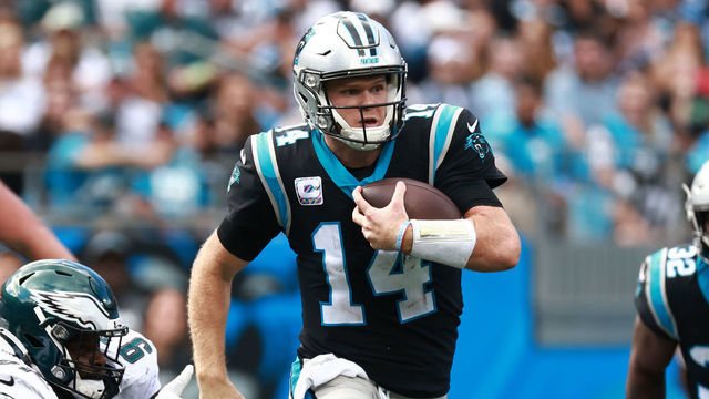 CHARLOTTE, NORTH CAROLINA - OCTOBER 10: Sam Darnold #14 of the Carolina Panthers is pressured by Javon Hargrave #97 of the Philadelphia Eagles during the football game at Bank of America Stadium on October 10, 2021 in Charlotte, North Carolina.