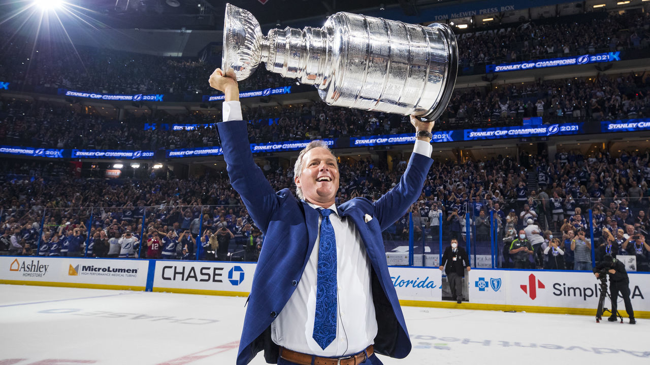 TAMPA, FL - JULY 7: Head Coach Jon Cooper of the Tampa Bay Lightning hoists the Stanley Cup overhead after the Tampa Bay Lightning defeated the Montreal Canadiens in Game Five to win the best of seven game series 4-1 during the Stanley Cup Final of the 2021 Stanley Cup Playoffs at Amalie Arena on July 7, 2021 in Tampa, Florida.