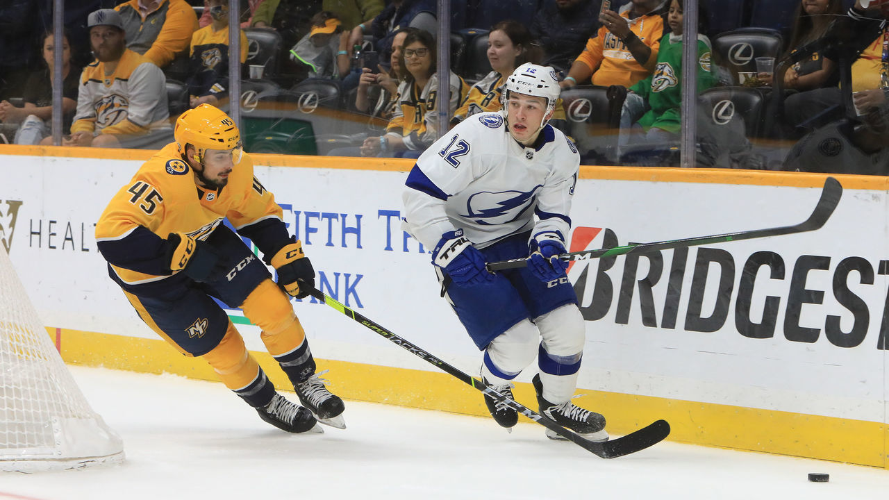 NASHVILLE, TN - OCTOBER 02: Nashville Predators defenseman Alexandre Carrier (45) defends against Tampa forward Alex Barre-Boulet (12) during the NHL preseason game between the Nashville Predators and Tampa Bay Lightning, held on October 2, 2021, at Bridgestone Arena in Nashville, Tennessee.
