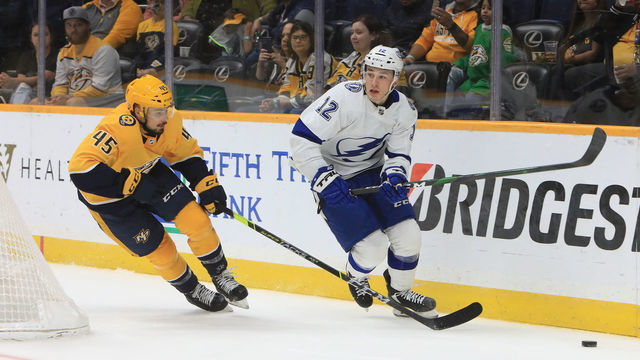 NASHVILLE, TN - OCTOBER 02: Nashville Predators defenseman Alexandre Carrier (45) defends against Tampa forward Alex Barre-Boulet (12) during the NHL preseason game between the Nashville Predators and Tampa Bay Lightning, held on October 2, 2021, at Bridgestone Arena in Nashville, Tennessee.