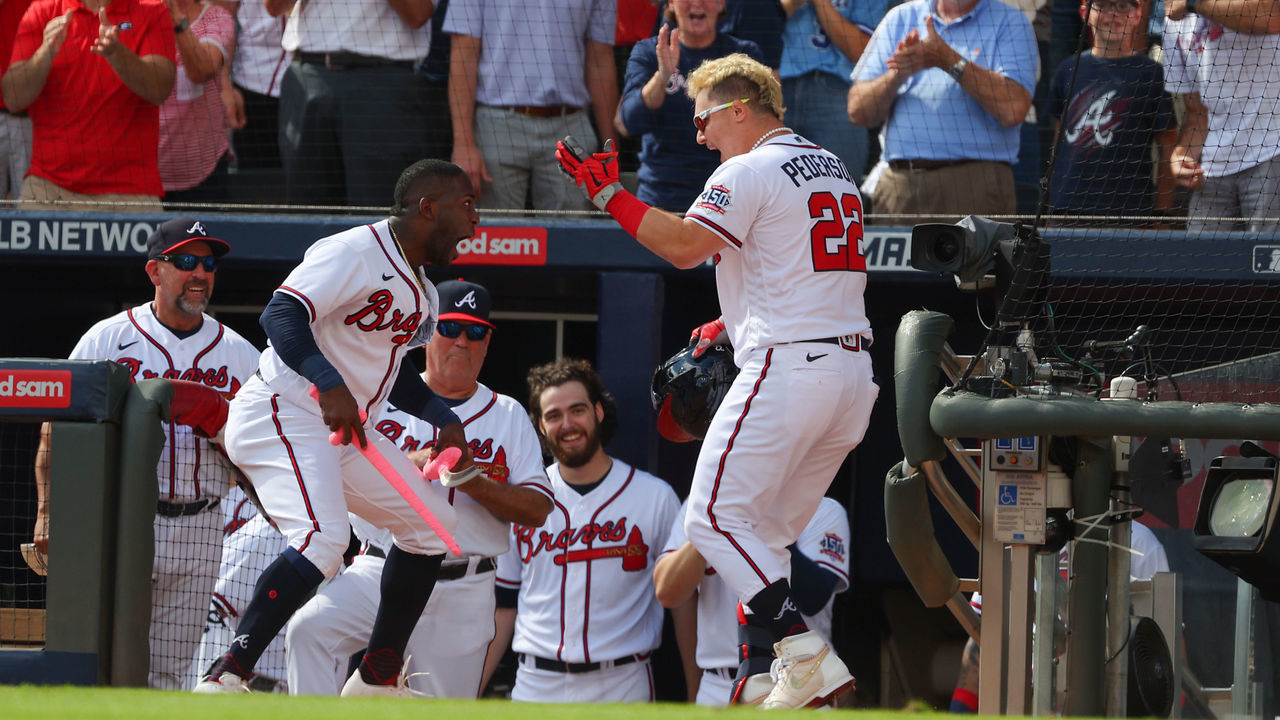 ATLANTA, GEORGIA - OCTOBER 11: Joc Pederson #22 of the Atlanta Braves celebrates with Guillermo Heredia #38 after hitting a three run home during the fifth inning against the Milwaukee Brewers in game 3 of the National League Division Series at Truist Park on October 11, 2021 in Atlanta, Georgia.