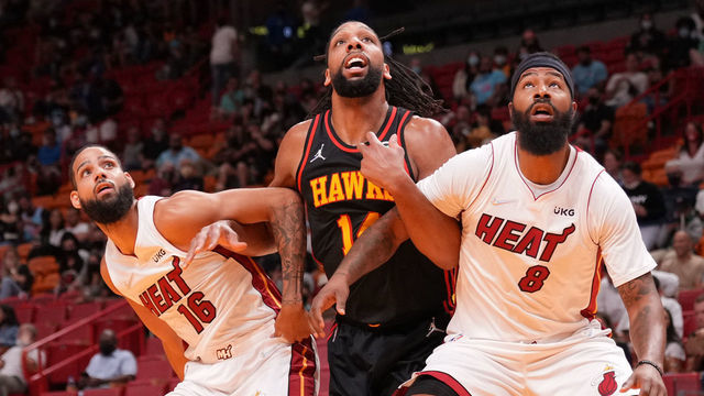 MIAMI, FLORIDA - OCTOBER 04: Caleb Martin #16 and Markieff Morris #8 of the Miami Heat box out Jahlil Okafor #14 of the Atlanta Hawks on a rebound in a preseason game at FTX Arena on October 04, 2021 in Miami, Florida. NOTE TO USER: User expressly acknowledges and agrees that, by downloading and/or using this Photograph, user is consenting to the terms and conditions of the Getty Images License Agreement. Mandatory Copyright Notice: Copyright 2021 NBAE