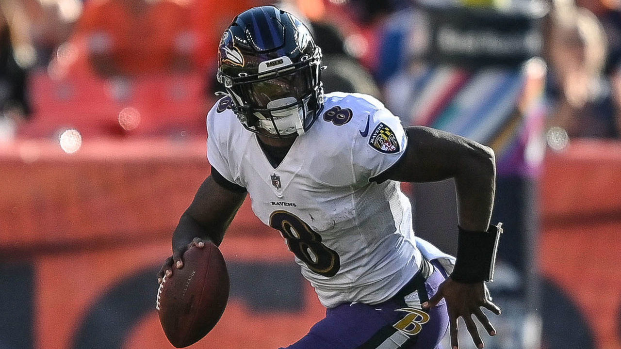 DENVER, CO - OCTOBER 3: Lamar Jackson #8 of the Baltimore Ravens rolls out of the pocket in the third quarter of a game against the Denver Broncos at Empower Field at Mile High on October 3, 2021 in Denver, Colorado.