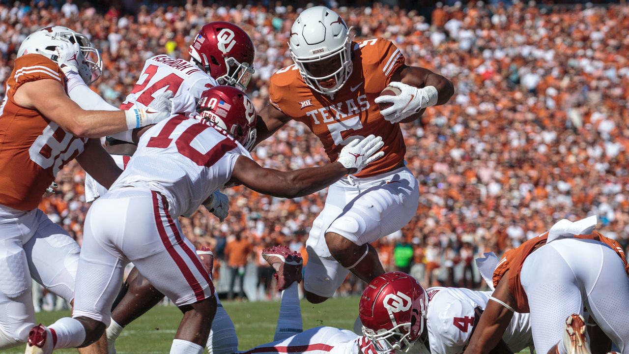 DALLAS, TX - OCTOBER 09: Texas Longhorns running back Bijan Robinson (5) leaps over the line towards the end zone against the Oklahoma Sooners on October 9th, 2021 at Cotton Bowl Stadium in Dallas, Texas.