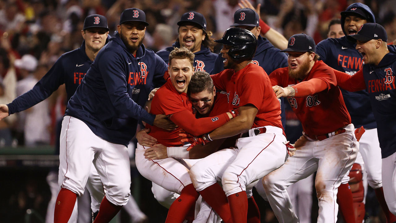 BOSTON, MASSACHUSETTS - OCTOBER 11: Enrique Hernandez #5 of the Boston Red Sox celebrates his game winning sacrifice fly with teammates in the ninth inning against the Tampa Bay Rays during Game 4 of the American League Division Series at Fenway Park on October 11, 2021 in Boston, Massachusetts.