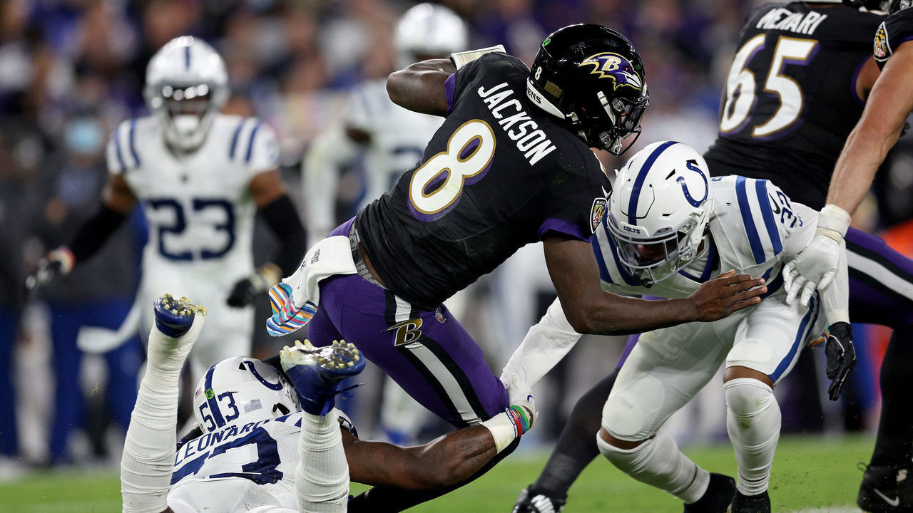 BALTIMORE, MARYLAND - OCTOBER 11: Lamar Jackson #8 of the Baltimore Ravens is tackled by Darius Leonard #53 and Kenny Moore II #23 of the Indianapolis Colts during the first quarter in a game at M&T Bank Stadium on October 11, 2021 in Baltimore, Maryland.