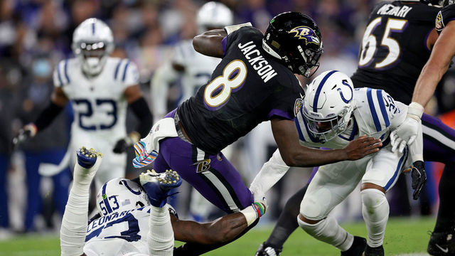 BALTIMORE, MARYLAND - OCTOBER 11: Lamar Jackson #8 of the Baltimore Ravens is tackled by Darius Leonard #53 and Kenny Moore II #23 of the Indianapolis Colts during the first quarter in a game at M&T Bank Stadium on October 11, 2021 in Baltimore, Maryland.