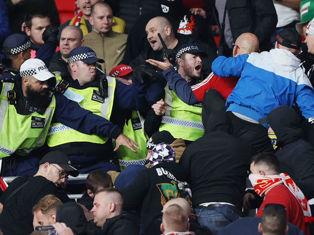 LONDON, ENGLAND - OCTOBER 12: Police clash with Hungary fans during the 2022 FIFA World Cup Qualifier match between England and Hungary at Wembley Stadium on October 12, 2021 in London, England.