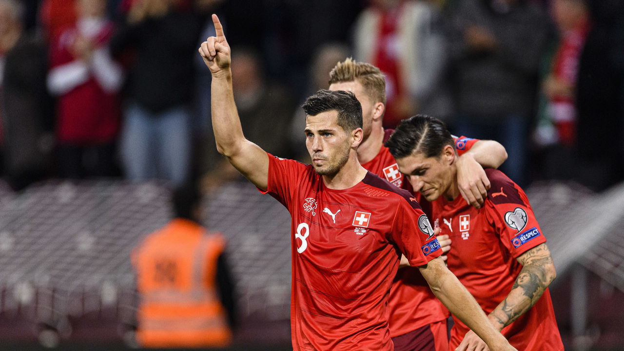 GENEVA, SWITZERLAND - OCTOBER 09: Remo Freuler of Switzerland (L) celebrate his teammate goals during the 2022 FIFA World Cup Qualifier match between Switzerland and Northern Ireland at Stade de Geneve on October 9, 2021 in Geneva, Switzerland.