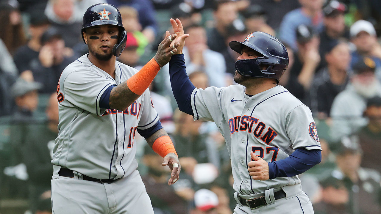 CHICAGO, ILLINOIS - OCTOBER 12: Jose Altuve #27 and Martin Maldonado #15 of the Houston Astros congratulate each other after scoring on a 2- RBI double by Alex Bregman #2 during the 4th inning of Game 4 of the American League Division Series against the Chicago White Sox at Guaranteed Rate Field on October 12, 2021 in Chicago, Illinois.