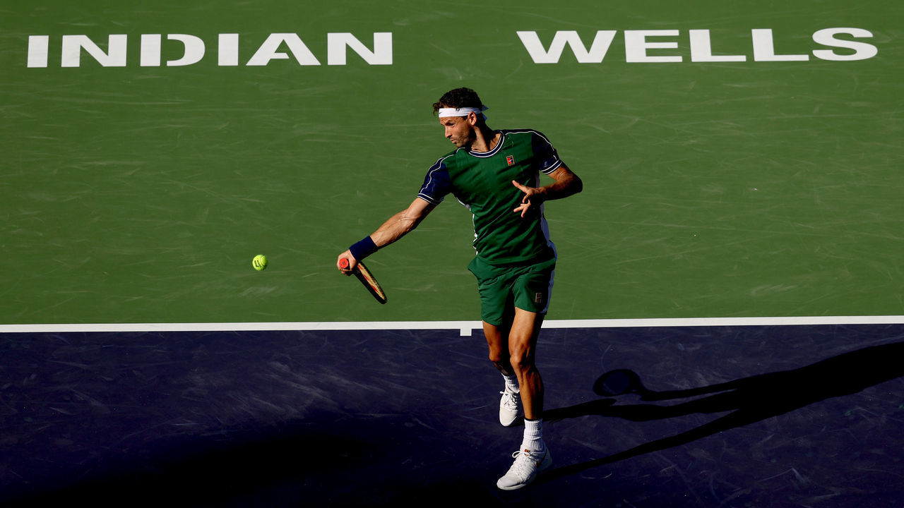 INDIAN WELLS, CALIFORNIA - OCTOBER 13: Grigor Dimitrov of Bulgaria returns a shot to Daniil Medvedev of Russia during the BNP Paribas Open at the Indian Wells Tennis Garden on October 13, 2021 in Indian Wells, California.