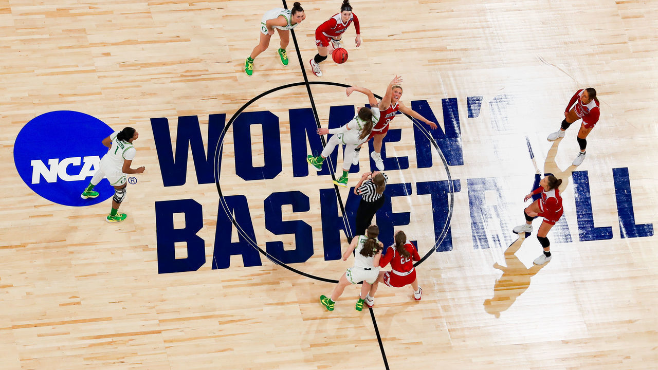 SAN ANTONIO, TEXAS - MARCH 22: Sedona Prince #32 of the Oregon Ducks and Macy Guebert #3 of the South Dakota Coyotes tip off in the first round game of the 2021 NCAA Women's Basketball Tournament at the Alamodome on March 22, 2021 in San Antonio, Texas.