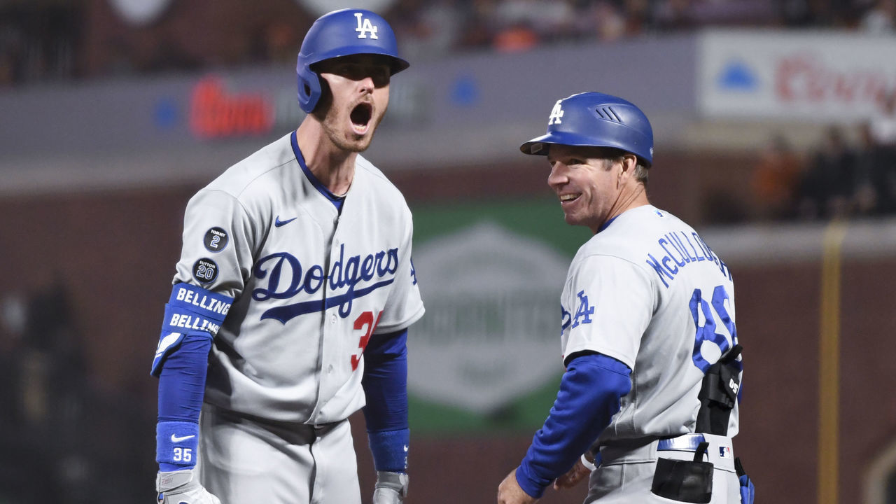 San Francisco, CA - October 14: Los Angeles Dodgers' Cody Bellinger, left, yells to the dugout after hitting the go-ahead RBI single while first base coach Clayton McCullough smiles during the ninth inning in game five of the 2021 National League Division Series against the San Francisco Giants at Oracle Park on Thursday, Oct. 14, 2021 in San Francisco, CA. (Wally Skalij / Los Angeles Times via Getty Images)