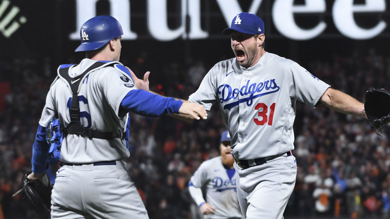 San Francisco, CA - October 14: Los Angeles Dodgers starting pitcher Max Scherzer, right, celebrates with Will Smith after striking out San Francisco Giants' Wilmer Flores to end game five of the 2021 National League Division Series at Oracle Park on Thursday, Oct. 14, 2021 in San Francisco, CA. The Dodgers won 2-1. (Wally Skalij / Los Angeles Times via Getty Images)