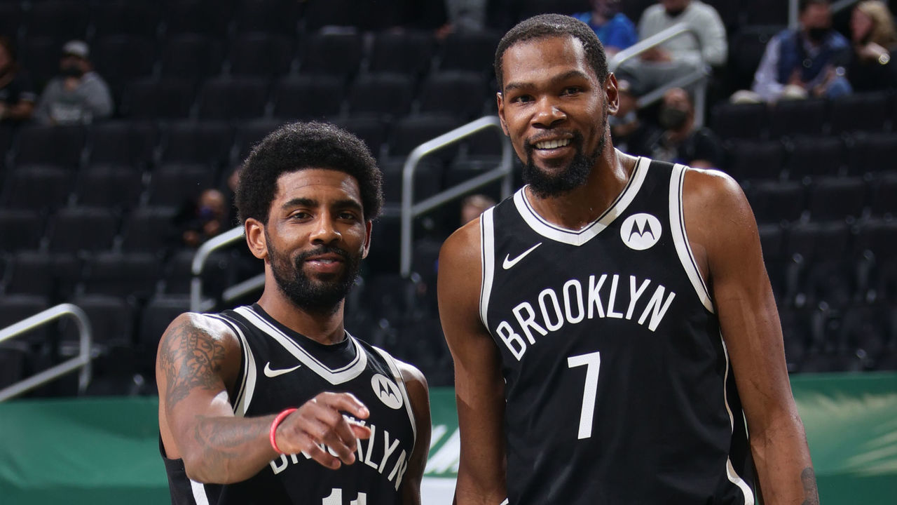 MILWAUKEE, WI - MAY 4: Kyrie Irving #11 and Kevin Durant #7 of the Brooklyn Nets smile during the game against the Milwaukee Bucks on May 4, 2021 at the Fiserv Forum Center in Milwaukee, Wisconsin. Mandatory Copyright Notice: Copyright 2021 NBAE .