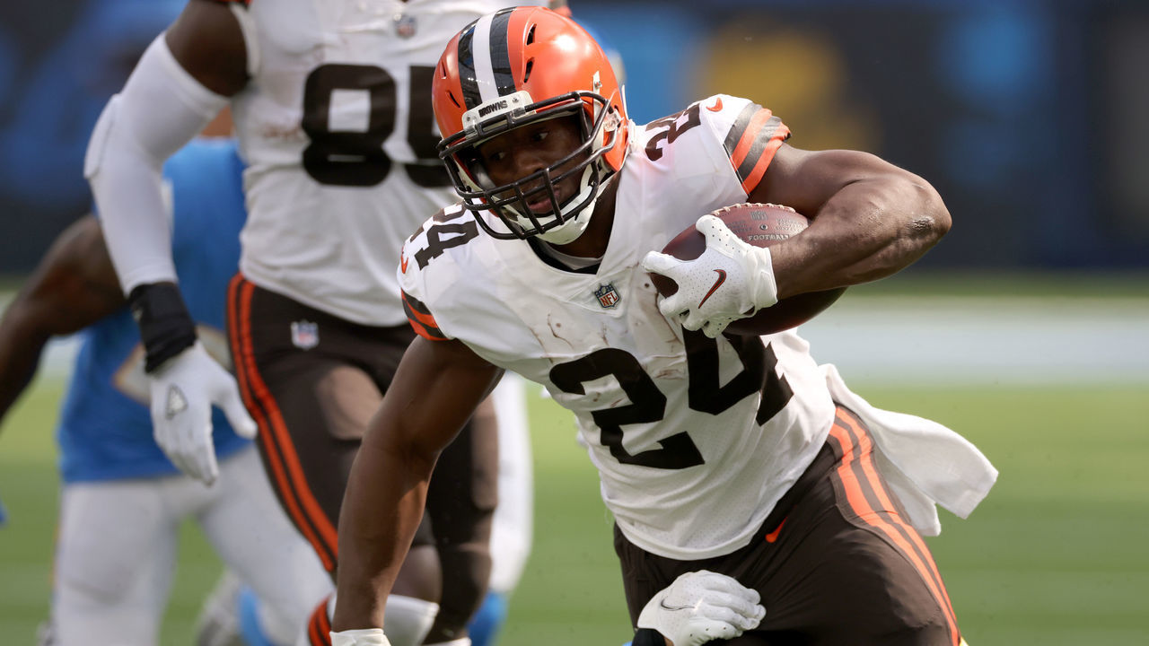 INGLEWOOD, CALIFORNIA - OCTOBER 10: Nick Chubb #24 of the Cleveland Browns is tackled by Drue Tranquill #49 of the Los Angeles Chargers during the first quarter at SoFi Stadium on October 10, 2021 in Inglewood, California.