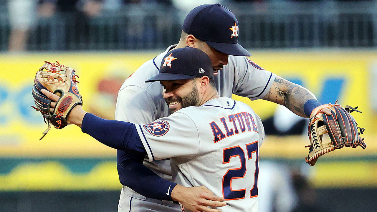 CHICAGO, ILLINOIS - OCTOBER 12: Jose Altuve #27 and Carlos Correa #1of the Houston Astros celebrate as the Astros defeat the Chicago White Sox 10-1 to win Game 4 of the American League Division Series at Guaranteed Rate Field on October 12, 2021 in Chicago, Illinois. The Astros won the American League Division Series 3-1 and will advance to the American League Championship Series.