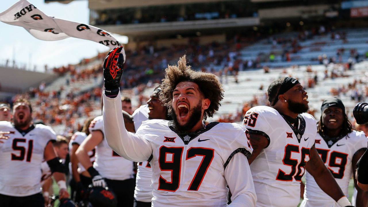 AUSTIN, TEXAS - OCTOBER 16: Ian Marshall #97 of the Oklahoma State Cowboys celebrates with teammates after defeating the Texas Longhorns at Darrell K Royal-Texas Memorial Stadium on October 16, 2021 in Austin, Texas.