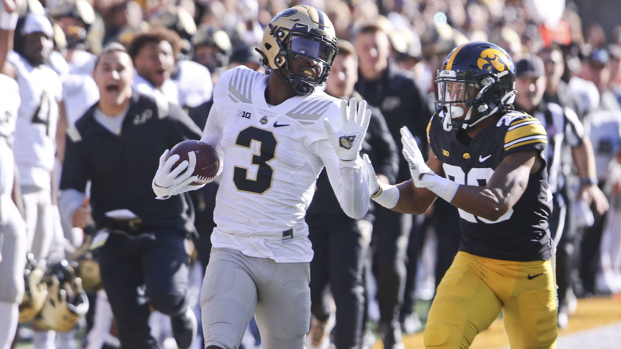 IOWA CITY, IOWA- OCTOBER 16: Wide receiver David Bell #3 of the Purdue Boilermakers runs down the sideline in the first half in front of defensive back Kaevon Merriweather #25 of the Iowa Hawkeyes at Kinnick Stadium on October 9, 2021 in Iowa City, Iowa.